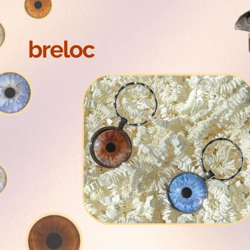 Două brelocuri cu iris PREYE - variante ochi căprui și albastru pe fundal decorativ